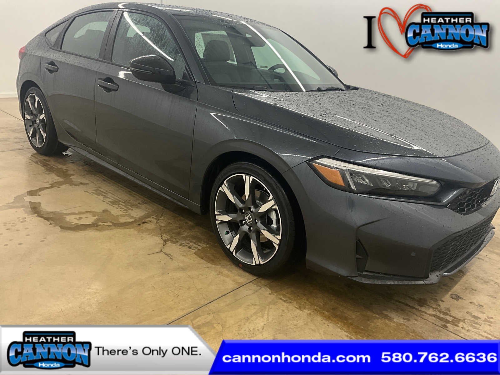 2026 Honda Civic Hatchback Hybrid Sport Touring in Meteorite Gray Metallic — front three-quarter view